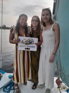 Traditional felucca sailboat gliding on the Nile river during sunset in Luxor Egypt